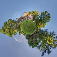 A small planet with a house and trees photo