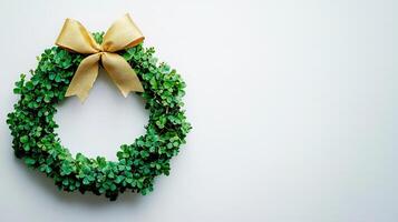 A wreath of green leaves with a gold bow on a white background photo