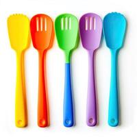 Five colorful plastic spoons are arranged in a row photo