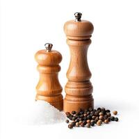 Two wooden pepper mills and salt shaker photo