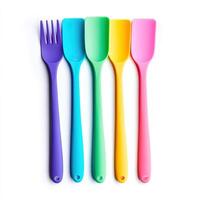 A set of four colorful plastic utensils photo