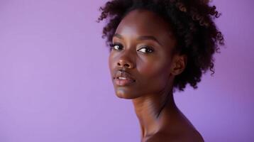 A captivating portrait of a person with dark features set against a purple background. photo