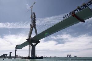 The bridge is being built over the water photo
