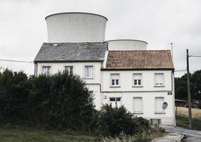 A white house with two chimneys photo