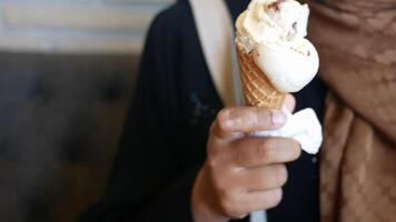 Enjoying ice cream cone in a cozy cafe setting video