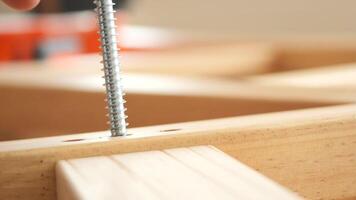 Close-Up of a Silver Screw Inserted into a Wooden Plank Structure video