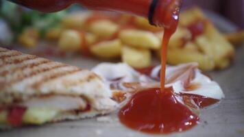 Enjoying a delicious sandwich with fries and sauce at a local eatery video