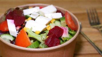 Fresh salad mix with vegetables and cheese in a bowl at lunch video