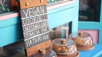 Vegan treats display at bakery with colorful storefront video