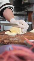 Chefs prepare and slice cheese in a busy kitchen environment video