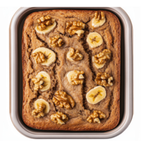 Delicious Banana Walnut Cake Freshly Baked in a Rectangular Pan Topped with Sliced Bananas and Nuts png