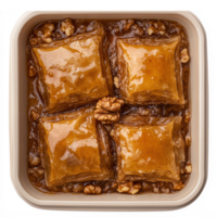 Delicious Baklava Dessert Display with Honey Syrup and Walnut Toppings in a Cream Colored Dish png