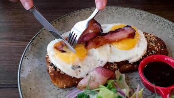 Delicious breakfast. fried eggs and crispy bacon on toast with salad video