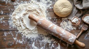 wooden rolling pin rests on flour dusted wooden surface, surrounded by scattered flour and ball of dough. scene captures essence of baking, evoking warm and inviting atmosphere photo