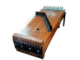 zither is a traditional musical instrument. zither is made of wood and strings. zither is played by plucking. zither on isolated white background photo