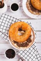 Sweet sandwich with butter, chocolate and sesame seeds on a plate on a table top and vertical view photo