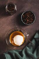 Affogato espresso coffee with vanilla ice cream in a cup on the table top and vertical view photo