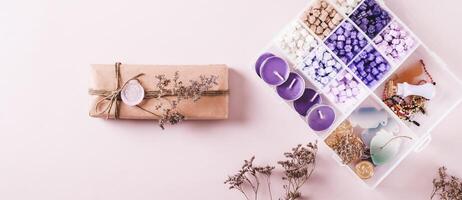Gift in Kraft Paper with Wax Seal and Making Kit on Pink top view web banner photo