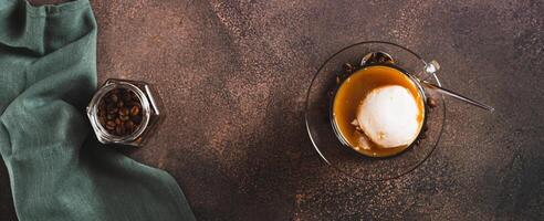 Affogato espresso coffee with vanilla ice cream in a cup on the table top view web banner photo