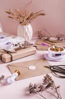 An envelope sealed with wax and a craft kit on the table vertical view photo