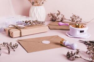 An envelope sealed with wax and a craft kit on the table photo