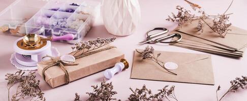 An envelope sealed with wax and a craft kit on the table web banner photo