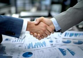 Business professionals finalize a deal with a handshake at a modern office during a meeting photo