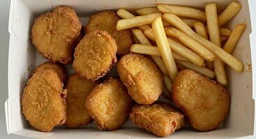Crispy Chicken Nuggets and French Fries in a Box photo