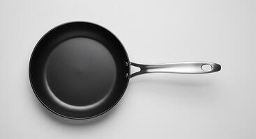 Elegant Black Frying Pan with Sleek Silver Handle on a White Background photo