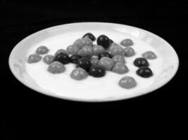 Chocolate and Orange Coated Candy Balls on Custard for different design purposes photo