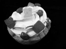 Cupcake with Toppings on Black Background wallpaper design photo