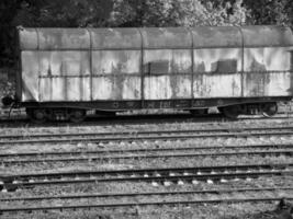 Train on Railway Track with Rolling Stock and Surrounding Plant Life wallpaper photo