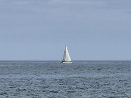 White sailboat in the open sea creative background photo