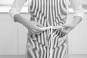 Woman tying apron strings creative background photo