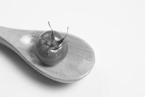 Tomato on a Wooden Spoon, Close View Background creative background photo