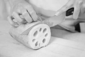 Person cutting lotus root creative background photo