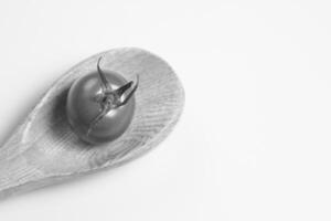 Tomato on a Wooden Spoon, Close View Background for different design purposes photo
