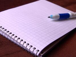 Empty notebook and a pen background wallpaper photo