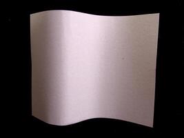 Wavy paper sheet over black background creative background photo