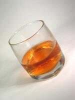 Glass of whiskey on white background creative background photo