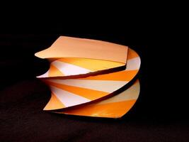 Orange and white papers for notes organized in a form of decorative towers wallpaper photo