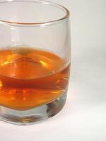 Glass of whiskey on white background for different design purposes photo