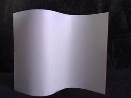 Wavy paper sheet over black background creative design photo