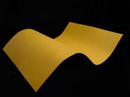 Wavy paper sheet over black background banner photo