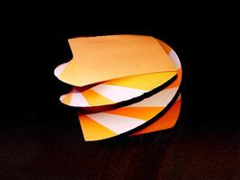 Orange and white papers for notes organized in a form of decorative towers creative background photo