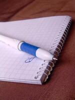 Empty notebook and a pen background creative background photo