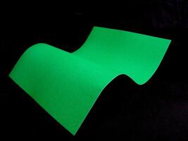Wavy paper sheet over black background designer wallpaper photo