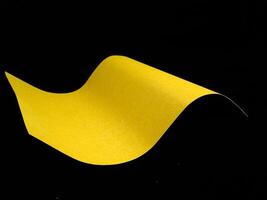 Wavy paper sheet over black background creative image photo
