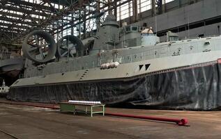 Military hovercraft docked in hangar photo