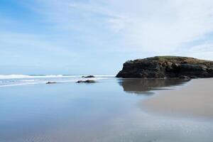 Tranquil scene with low tide at Cathedrals beach. Sunny day. No people. photo